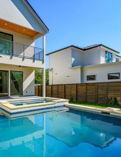 Modern two-story home with a small rectangular swimming pool in the backyard.