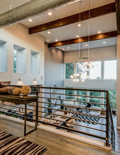 Modern loft space with exposed ductwork, high ceiling, and contemporary decor.
